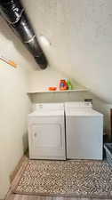 Laundry room featuring separate washer and dryer and light wood-style floors