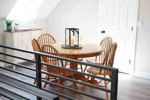 Dining area with lofted ceiling and wood finished floors