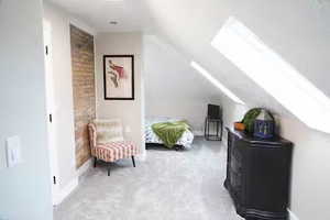 Bonus room with a skylight, vaulted ceiling, and concrete flooring