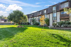 View of property's community with a yard