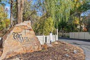 Community / neighborhood sign featuring view of scattered trees