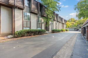 View of asphalt road featuring a residential view