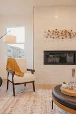 Sitting room featuring baseboards and wood finished floors