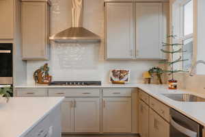 Kitchen featuring tasteful backsplash, light stone countertops, and stainless steel appliances