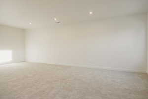 Spare room featuring light carpet and recessed lighting