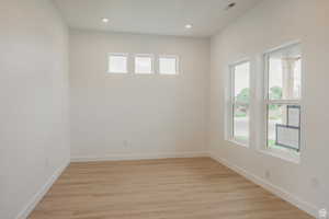 Unfurnished room with light wood-style floors and recessed lighting