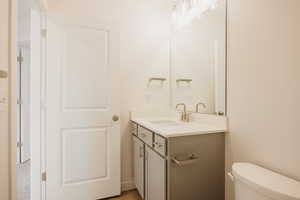 Half bathroom with toilet and vanity