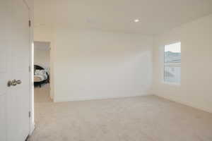 Unfurnished room featuring light carpet and recessed lighting