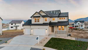 Modern farmhouse featuring board and batten siding, covered porch, roof with shingles, and driveway