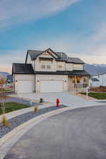 Modern inspired farmhouse with board and batten siding, a mountain view, roof with shingles, and covered porch