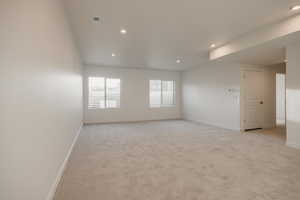 Unfurnished room featuring light carpet and recessed lighting