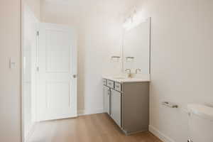 Half bath featuring vanity and light wood-style flooring
