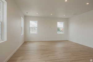 Empty room featuring recessed lighting and light wood-style flooring