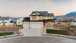 Modern inspired farmhouse featuring driveway, a mountain view, a garage, and a shingled roof