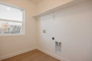 Laundry room with washer hookup, light wood-type flooring, and hookup for an electric dryer