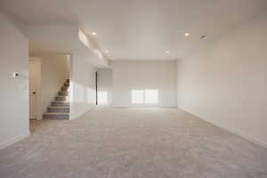 Empty room featuring light colored carpet and recessed lighting
