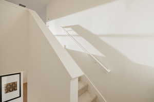 Stairway featuring wood finished floors