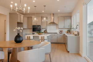 Kitchen featuring gray cabinets, light wood-style flooring, a kitchen island, a breakfast bar area, and backsplash