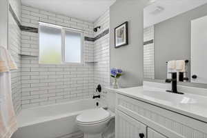 Bathroom with shower / bathtub combination and vanity