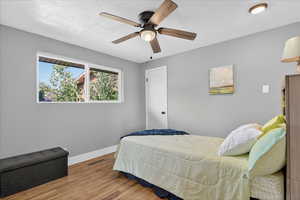 Bedroom with wood finished floors and a ceiling fan