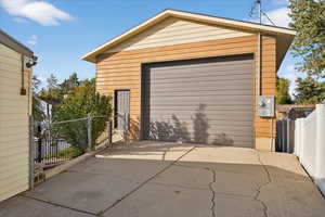 Detached garage featuring concrete driveway