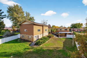 Rear view of property featuring a fenced backyard and a patio