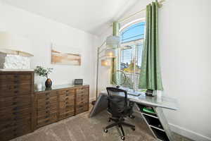 Office area with carpet and lofted ceiling