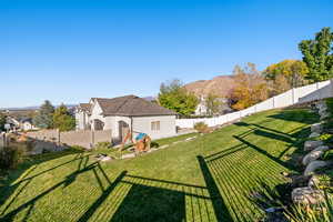 Fenced backyard featuring a mountain view