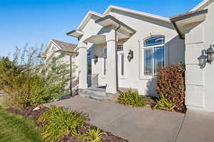 View of exterior entry featuring stucco siding