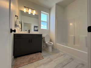 Full bath featuring vanity and bathtub / shower combination