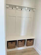 Mudroom featuring light wood-type flooring and baseboards