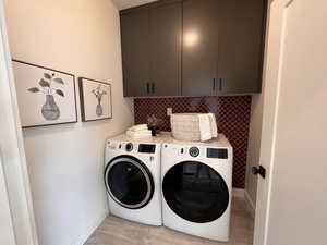 Laundry room featuring cabinet space and separate washer and dryer