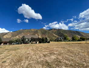 View of mountain backdrop featuring rural landscape