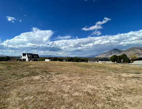 View of yard featuring a mountain view and a view of countryside