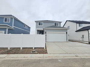 Traditional home with driveway and a garage
