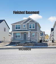 View of front facade featuring stone siding and board and batten siding