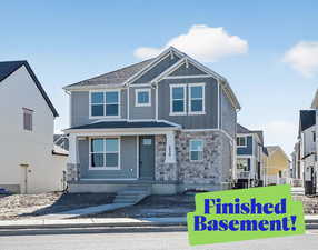 Craftsman-style home with stone siding and board and batten siding