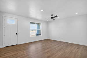 Foyer entrance with plenty of natural light, dark wood-style floors, recessed lighting, a ceiling fan, and a textured ceiling