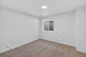 Empty room with baseboards and carpet floors