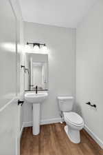 Bathroom with baseboards and wood finished floors