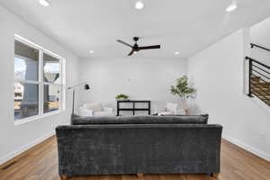 Living room with a ceiling fan, wood finished floors, and recessed lighting