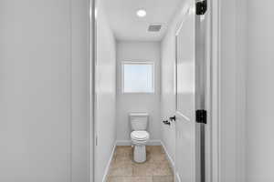 Bathroom with toilet and baseboards