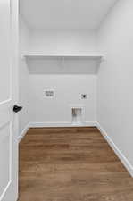 Washroom featuring hookup for an electric dryer, wood finished floors, and washer hookup
