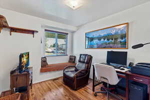 Office space with wood finished floors and baseboards
