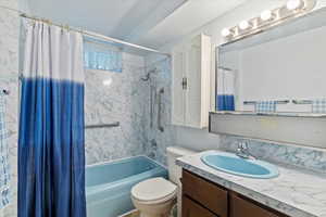 Full bath featuring shower / bathtub combination with curtain and vanity