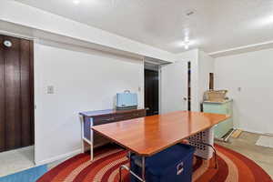 Office space featuring baseboards and a textured ceiling