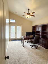 Office area featuring french doors, vaulted ceiling, light carpet, and ceiling fan