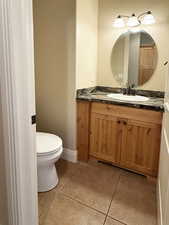 Bathroom with light tile patterned floors and vanity