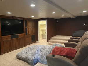 Cinema featuring recessed lighting, light colored carpet, beam ceiling, and a textured ceiling