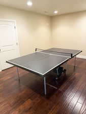 Game room featuring dark wood-style flooring and recessed lighting